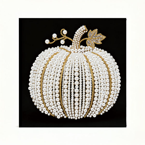 Decorative pumpkin made of pearls and gold accents on a black background