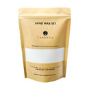 A stand-up pouch package for a Sand Wax Set by Candittle, featuring a metallic gold finish with a large white window on the front showing the wax inside, photographed on a white background.
