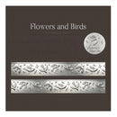 Silver floral and bird patterned wallpaper shown on a dark brown background, with two horizontal swatches of the embossed metallic design and a circular logo seal reading 'Silverlight Wallpaper'.