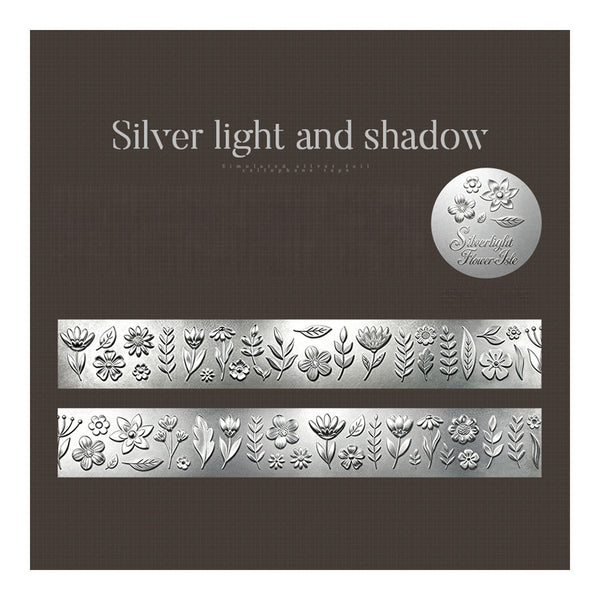 Silver floral embossed nail art foil sheets on a dark brown textured background, with the text 'Silver light and shadow' and a circular logo badge.