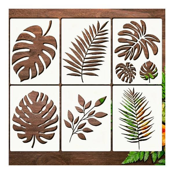 Six square decorative tiles arranged in a 2x3 grid, each featuring a different tropical leaf design in dark brown wood cutout over an off-white tile background. The leaves include monstera, palm, and fern motifs.