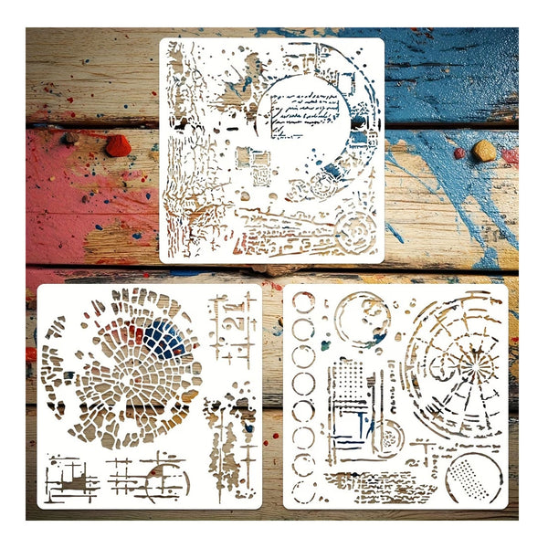 Four white stencils with intricate brown, blue, and gold artistic patterns, arranged on a rustic, paint-splattered wooden background.