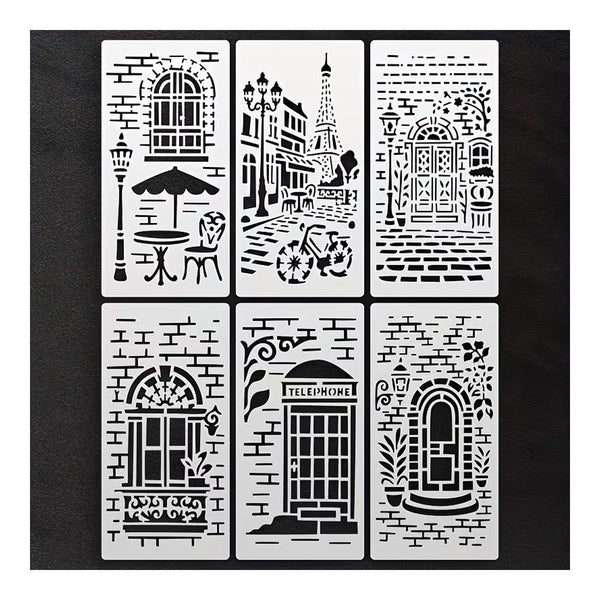 Six rectangular stencil templates arranged in a 2x3 grid on a black background. Each stencil features a different Parisian-themed design, including a cafe table and chair, Eiffel Tower and street scene, ornate doors, arched windows, a telephone booth, and a decorative archway, all in black cutout lines on white stencil sheets.