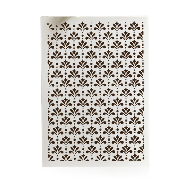 A rectangular stencil sheet featuring a repeating dark brown damask-style leaf and dot pattern on a white background, shown against a clean white backdrop.