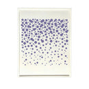 A square art print or card featuring a pattern of purple dots of varying sizes scattered across an off-white background, presented in a thin white frame against a solid white backdrop.