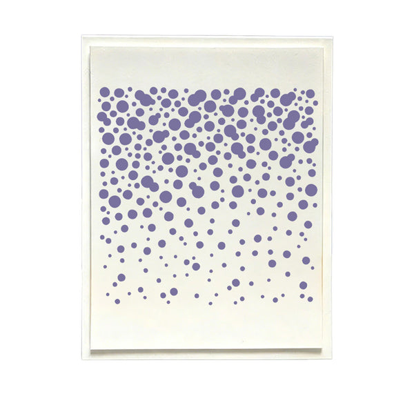 A square art print or card featuring a pattern of purple dots of varying sizes scattered across an off-white background, presented in a thin white frame against a solid white backdrop.