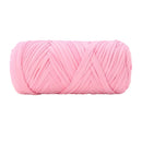 A single ball of light pink craft yarn with a textured, ribbed surface, isolated on a solid white background.