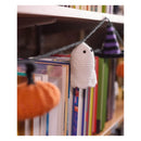 A Crochet Halloween book garland hanging on a wooden bookshelf, featuring a white ghost, an orange pumpkin, and a purple witch hat.