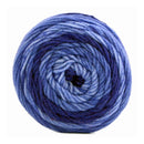 A single ball of variegated yarn wound in a spiral pattern, featuring shades of light blue, medium blue, and deep navy blue, isolated on a white background.