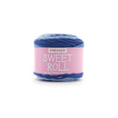 A skein of Premier Sweet Roll yarn in a variegated blue and purple colorway, wrapped in a pink paper label, on a white background.