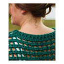 Close-up back view of a person wearing a dark green crocheted openwork top or shawl with a textured knit border and back panel.