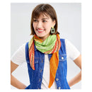 Woman wearing a colorful scarf and denim vest on a white background