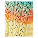 Close-up of a hand-knit textile with a multicolor striped pattern in mint green, orange, peach, and pale yellow, showing detailed knit textures.