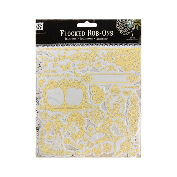 A package of Flocked Rub-Ons transfer stickers by Prima, featuring various ornate gold-colored designs on a white backing sheet, with a black header card.