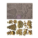 A rectangular silicone baking mold shown above several example holiday-themed embossed pieces, with dimension lines indicating 8 inches by 5 inches. The mold has multiple recessed Christmas designs including a tree, snowman, ornament, rabbit, and floral motifs.