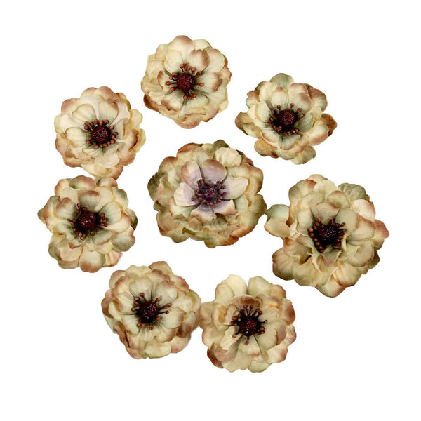 Eight artificial vintage-style flowers arranged in a loose circle on a plain white background. The flowers have layered cream and tan petals with muted brown edging and dark burgundy centers.