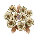 A cluster of artificial rose-style flowers with layered cream and muted sage green petals, brown leaves, and gold-toned centers on a plain white background.