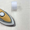 Iron with a roll of white fabric on a light gray background