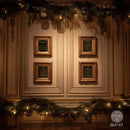 Four framed black and gold plaques mounted in a 2x2 grid on a warm beige paneled wall, decorated with green garlands and warm string lights above and below.