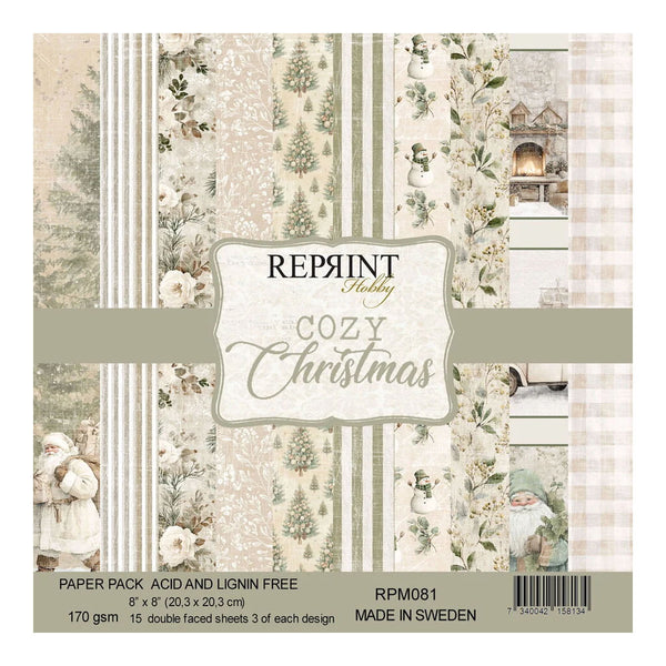 A square paper pack labeled 'Reprint Hobby Cozy Christmas' with multiple cream-toned holiday patterned sheets visible, including stripes, floral motifs, snowy figures, and a small gnome. Product text at the bottom reads 'Paper Pack Acid and Lignin Free', 'RPM081', and 'Made in Sweden'.