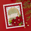 A handmade Christmas greeting card with layered red and green poinsettia details, a gold arched banner reading 'Merry Christmas,' and scalloped red borders, photographed on a red background with holiday greenery and gold ornaments.