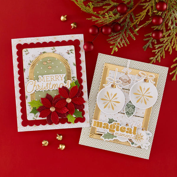 Two handmade Christmas greeting cards displayed on a red background with holiday greenery and red berries. One card features red poinsettias and the text 'Merry Christmas,' and the other shows white ornament cutouts with gold details and the text 'magical moments.