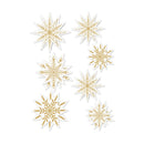 Seven gold and white laser-cut snowflake decorations of various sizes arranged on a plain white background.