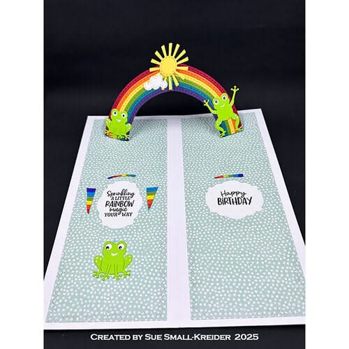 Card with a rainbow, sun, and frogs on a black background