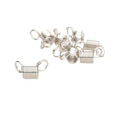 A pile of small silver metal spring clamps with attached jump rings, shown on a plain white background.