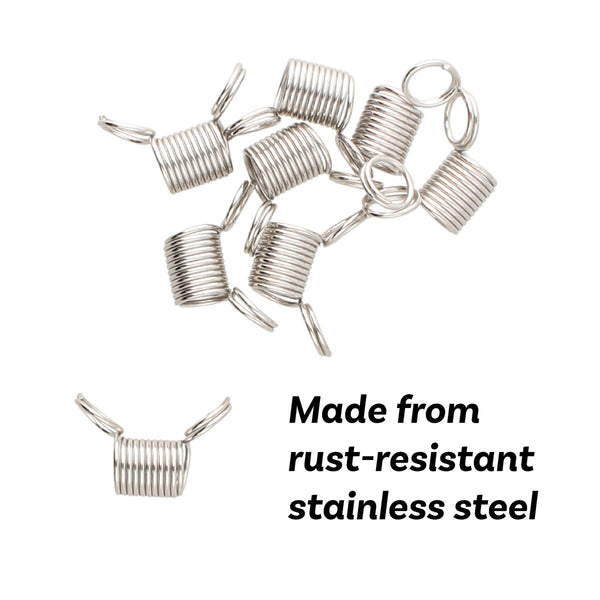 A pile of small silver metal spring clamps with attached jump rings, shown on a plain white background.
