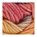 Close-up of a skein of variegated yarn with alternating sections of coral pink, cream, golden yellow, and orange-brown tones.