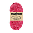 A skein of Scheenjes Stone Washed XL yarn in a vibrant pink color, featuring a beige paper label with black text, set against a plain white background.
