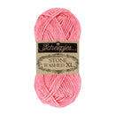 A skein of pink Scheepjes Stone Washed XL yarn with its paper label band, centered on a plain white background.