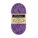 A skein of Scheepjes Stone Washed XL yarn in a heathered purple shade, featuring a beige paper label with black text, set against a plain white background.