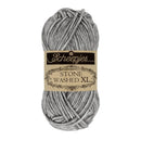 A skein of Scheepjes Stone Washed XL yarn with a beige and black paper label, shown on a solid white background.