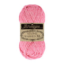 A skein of pink Scheepjes Stone Washed XL yarn with its paper label band, centered on a plain white background.