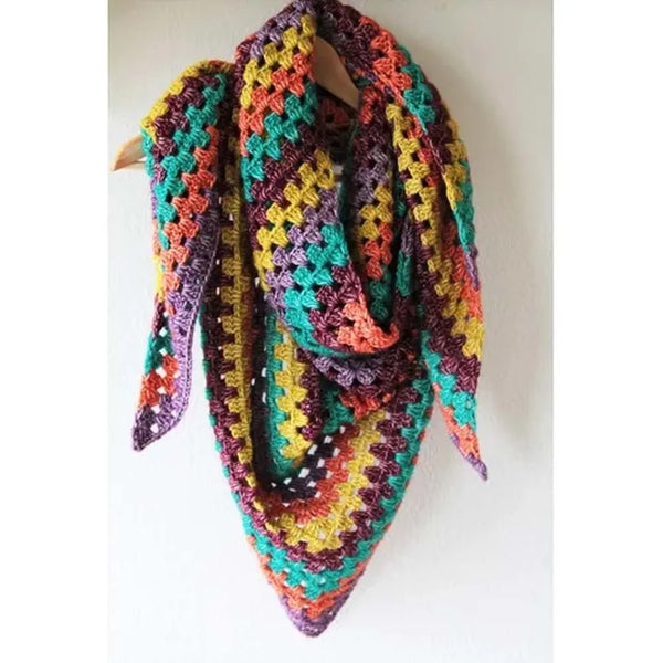 A multicolor crocheted triangular scarf draped over a wooden hanger against a plain white wall.