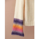 Close-up of a sweater sleeve with colorful stripes on a beige background