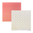 Two square sheets of paper on a white background: one solid coral pink sheet and one patterned sheet with a cream base and repeating gray snowflake motifs accented by small red and olive dots.