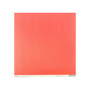 A square coral red paper sheet with a white border and small printed text along the bottom edge, centered on a white background.