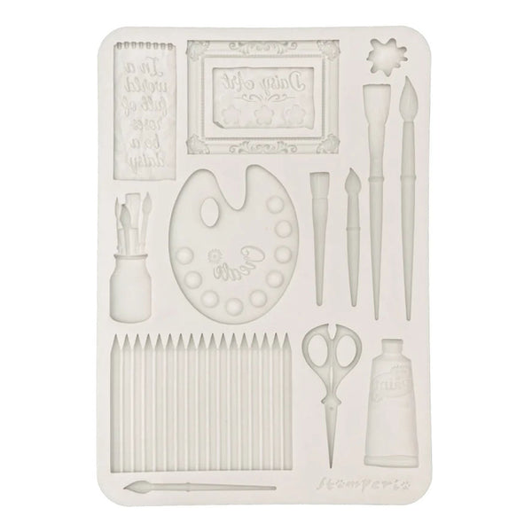 Decorative mold with artist-themed design on a white background