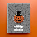 A square Halloween greeting card or print featuring a black cat sitting on a carved orange pumpkin inside a gray spiderweb, with the text 'HAVE A PURR-FECTLY SPOKKY HALLOWEEN' below. The card is centered on an orange background.