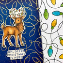 A close-up of a Christmas-themed printed surface featuring a brown deer sticker with antlers decorated with red, yellow, and green ornaments, above the text 'OH, DEER! CHRISTMAS IS HERE' on a dark blue background with gold wireframe light-bulb outlines. To the right is a white patterned section with colorful holiday lights on black wires.
