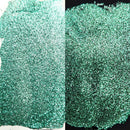 Close-up of green glitter on a white and black background