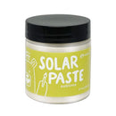 Jar of solar paste with a black lid on a white background