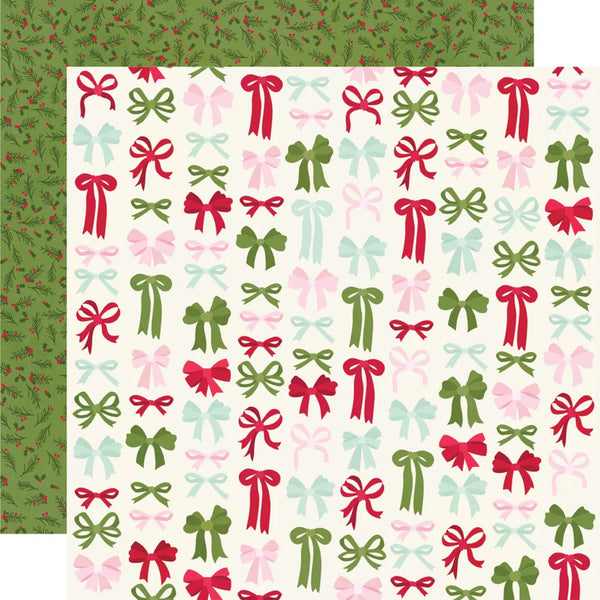 A sheet of holiday-themed patterned paper with a cream background covered in repeating bow motifs in red, green, pink, and light blue, with a coordinating green patterned border visible along the top and left edges.