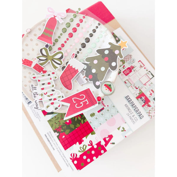 A Christmas-themed scrapbook paper pad featuring festive patterns like a Christmas tree, stockings, ornaments, and red gift boxes, with the text 'all the love' and '6x8 scrapbook paper'.