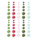 A sheet of decorative adhesive dots arranged in vertical columns on a white background. The dots come in green, red, pink, and light blue colors, with some featuring a glittery texture and others having a glossy, translucent look.