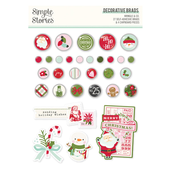 A sheet of Christmas-themed decorative adhesive brads and chipboard pieces from Simple Stories, featuring round buttons, small dots, labels, and cutout shapes in red, green, white, and black holiday colors.