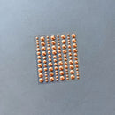 A sheet of metallic rose gold adhesive gems in various sizes, arranged in vertical columns on a textured gray background.